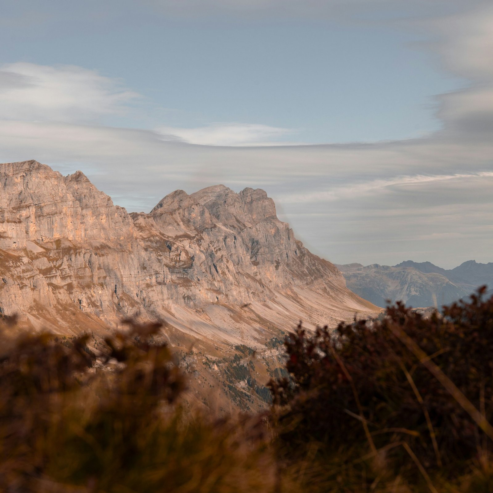 a view of a mountain range from the top of a hill